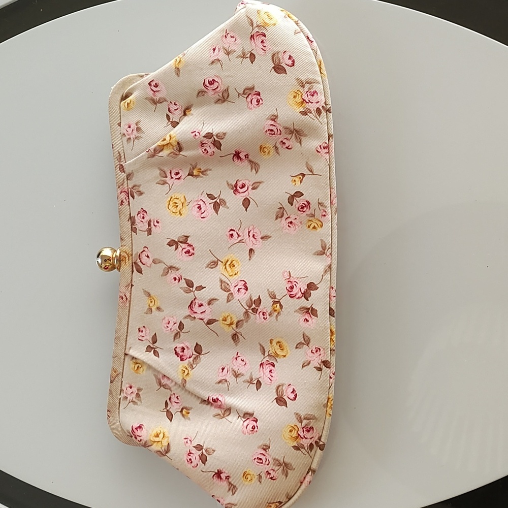 Unknown brand tan base with flowers design thru-out the purse